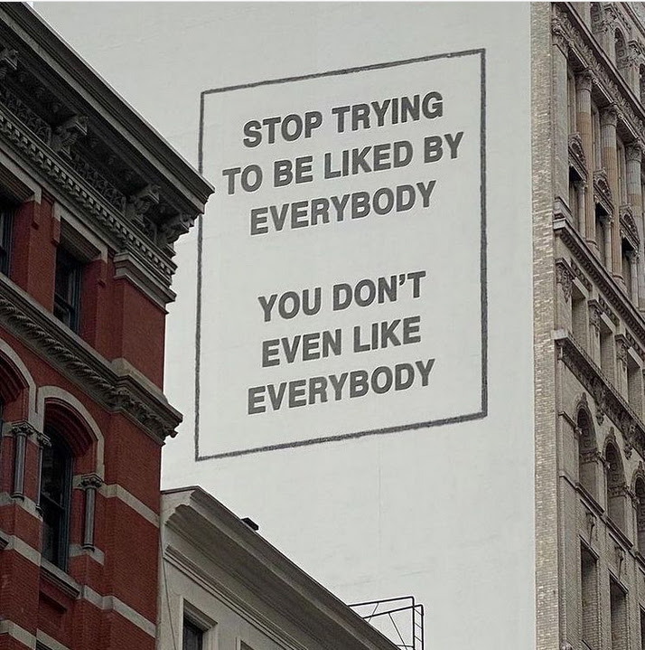 Billboard on the side of a building that says, "Stop trying to be liked by everybody. You don't even like everybody."