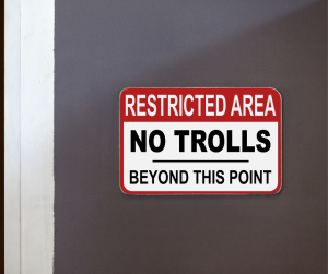 Sign on a door that reads restricted area no trolls beyond this point